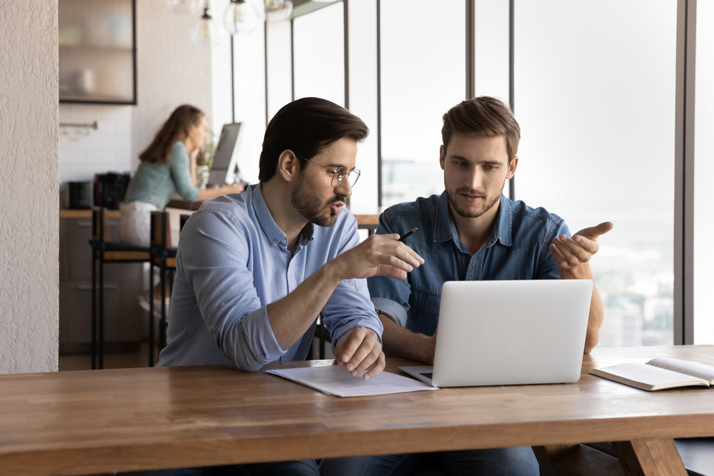 Employees discussing custom software needs